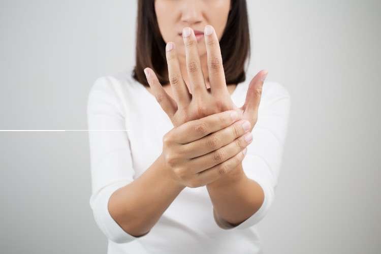 Woman massaging her wrist and hand