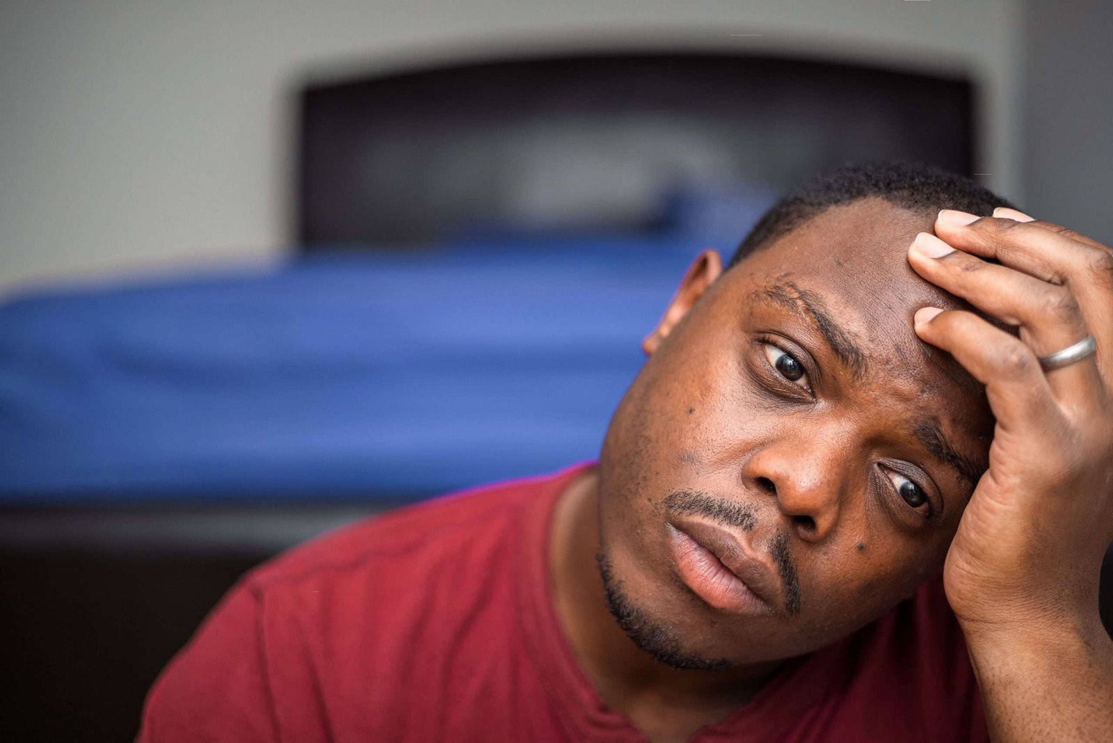 Man holding his forehead with a worried expression