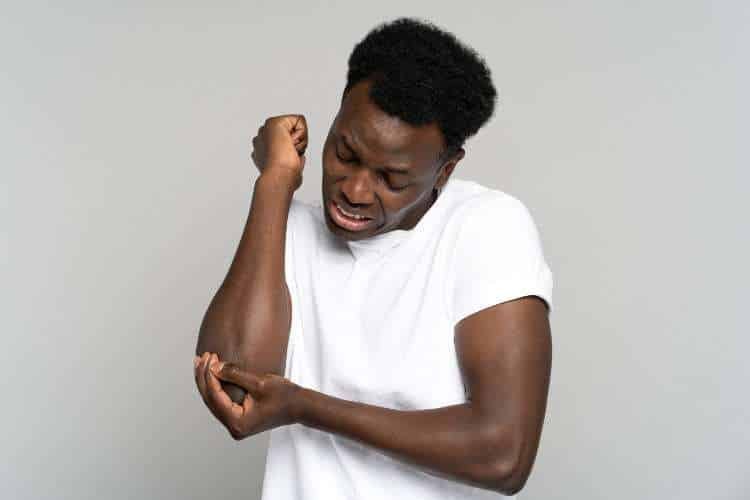 Man holding his elbow in pain