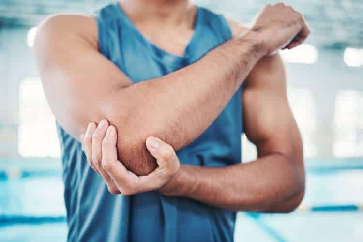 Person holding the outer elbow