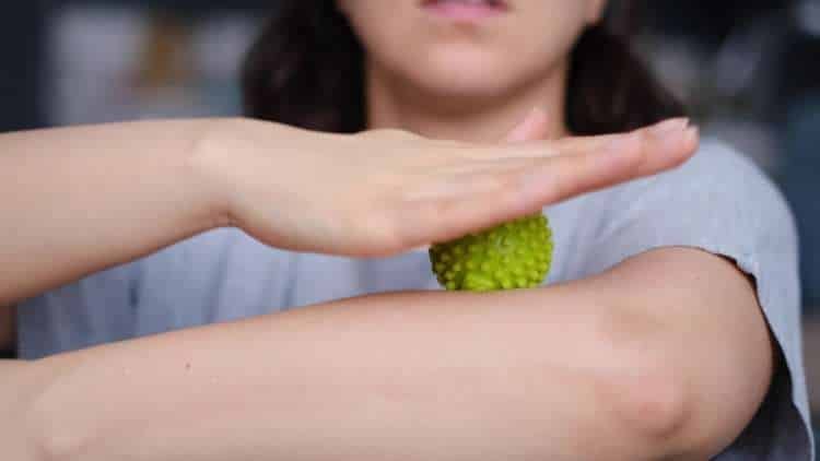 Person rolling their forearm on a massage ball