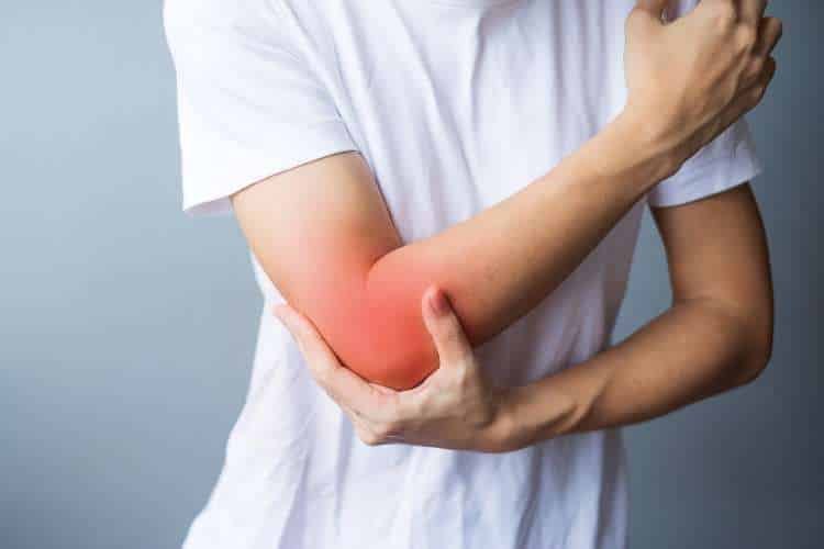 Person holding a painful elbow