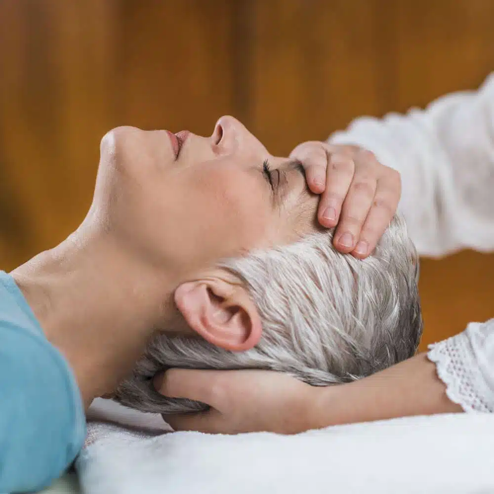Marma Therapy. Ayurveda Face Therapy Marma therapy. Beautiful senior woman lying on massage table and enjoying Ayurveda Facial treatment.